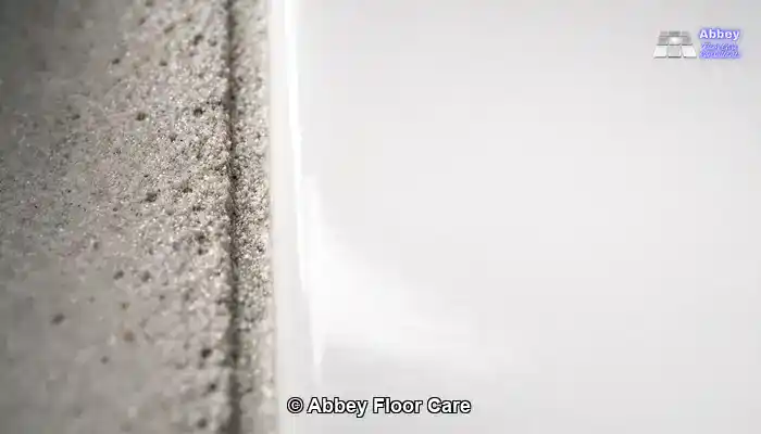 Close-up comparison between dense porcelain tile and porous stained grout.